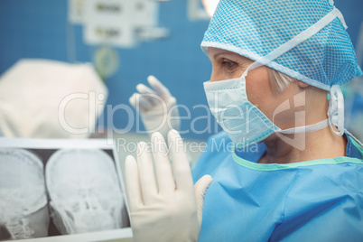 Female surgeon wearing surgical mask in operation theater