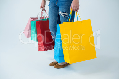 Woman carrying colorful shopping bags