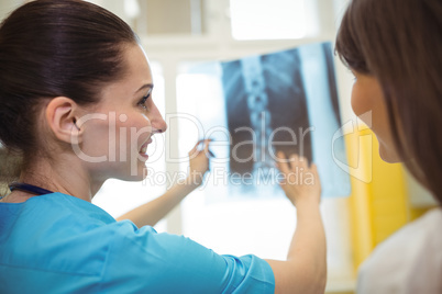 Female nurse discussing x-ray report with patient