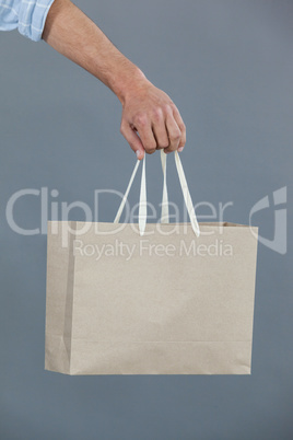 Hand of a man holding shopping bag