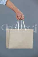 Hand of a man holding shopping bag