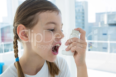 Girl using asthma pump