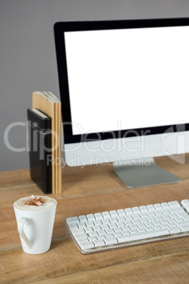 Desktop pc with cup of coffee and diary