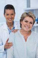 Smiling female doctor and patient in clinic