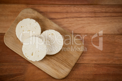 Slices of cheese on chopping board