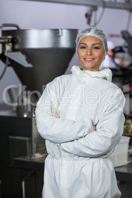 Female butcher standing with arms crossed