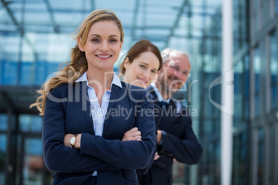 Happy businesspeople standing with their hands folded