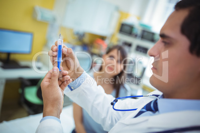 Doctor preparing a syringe to give an injection