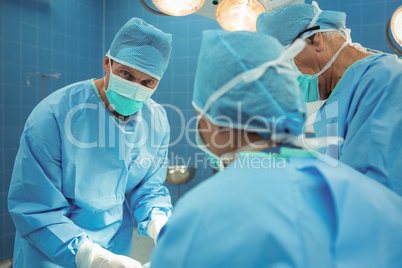 Team of surgeons performing operation in operation theater