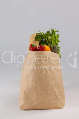 Fruits and vegetables in brown grocery bag