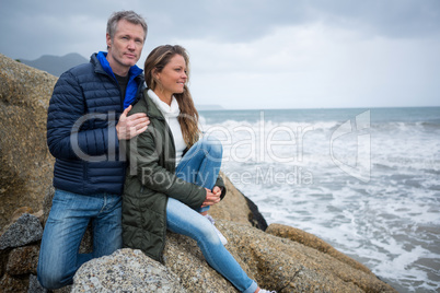 Couple sitting on rocks and enjoying the view