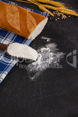 Bread loaf with wheat grains and flour