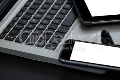 Laptop, digital tablet, smartphone and earphones