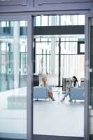 Businesswomen sitting in armchair and having a conversation