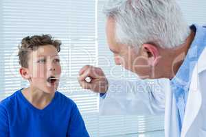 Doctor examining patients mouth