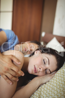 Romantic couple sleeping on bed