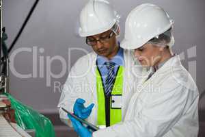 Technicians looking at digital tablet