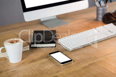 Desktop pc and smartphone with cup of coffee