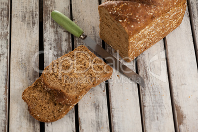 Sliced bread loaf with knife