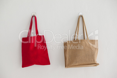 Red and beige fabric bags hanging on wall