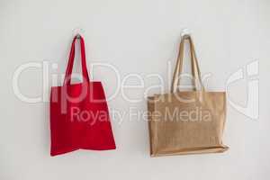 Red and beige fabric bags hanging on wall
