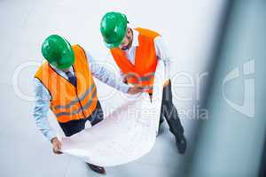 Architects checking blueprint