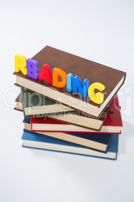 Reading letter blocks on stack of books