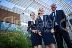 Confident businesspeople standing in the office premises