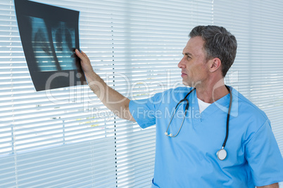 Surgeon analyzing x-ray report