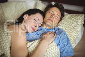 Romantic couple sleeping on bed