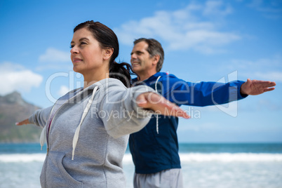 Couple performing stretching exercise