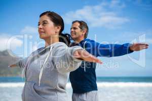 Couple performing stretching exercise