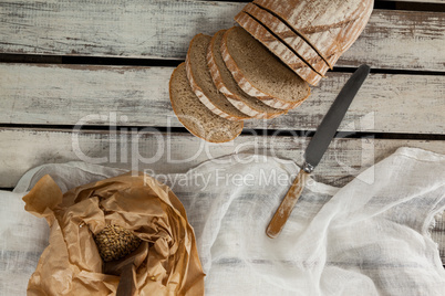 Sliced loaf of bread with knife