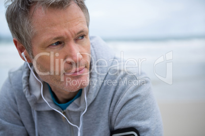 Handsome man listening music on headphones