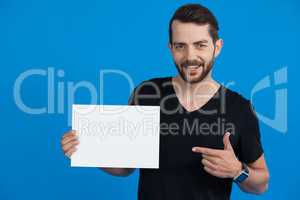 Handsome man holding a blank placard