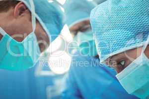 Team of surgeons performing operation in operation theater