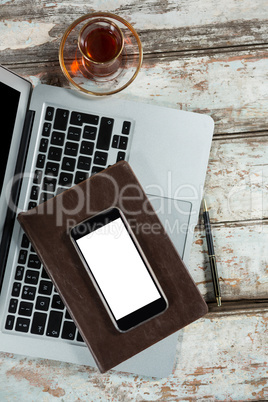 Laptop, smartphone and diary with coffee cup