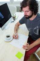 Business executive writing on a document