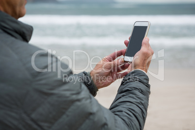 Man using mobile phone on beach