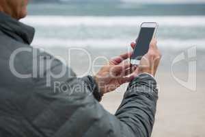Man using mobile phone on beach