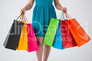 Woman carrying colorful shopping bags
