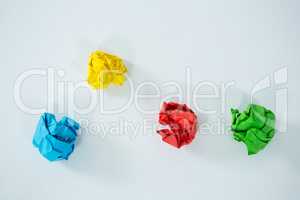 Multi-colored crumbled paper on white background