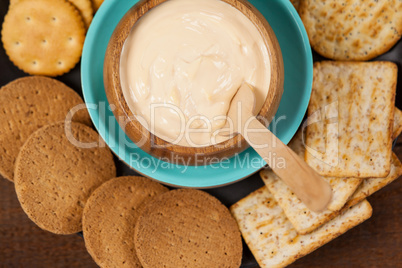 Biscuits with cheese sauce in plate on wooden table