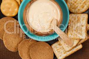 Biscuits with cheese sauce in plate on wooden table