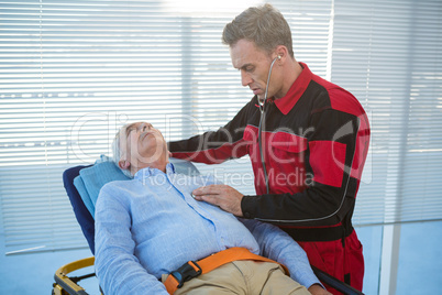 Paramedic examining the patient