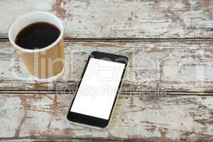 Close-up of black coffee and mobile phone