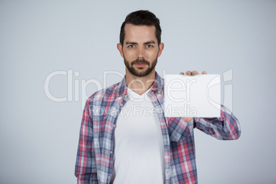 Confident man holding a blank placard