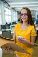 Female business executive using on mobile phone in office