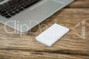 Laptop with sticky notes on wooden table