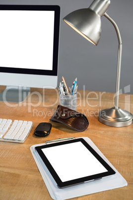 Desktop pc, digital tablet and table lamp